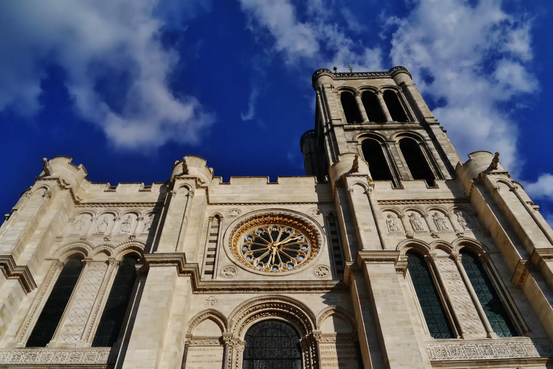 The west facade of the Basilica of Saint-Denis, its surviving tower and rose window rising above the forecourt